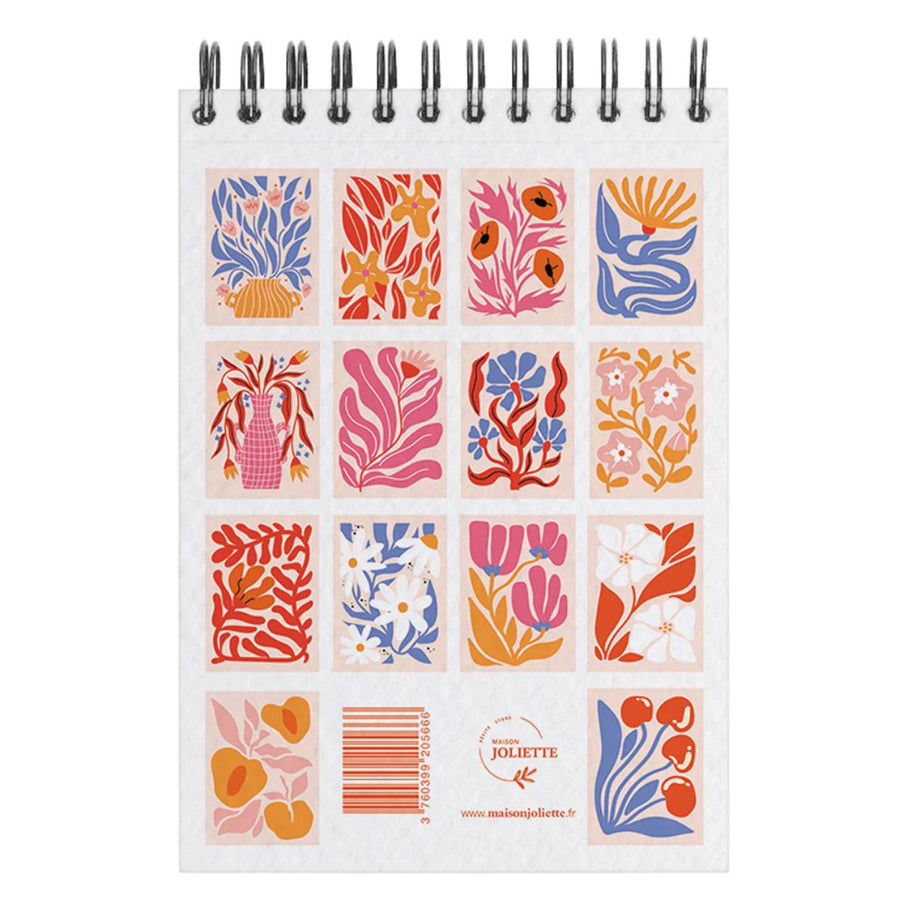 Carnet de coloriage floral ouvert, pages illustrées en détail.