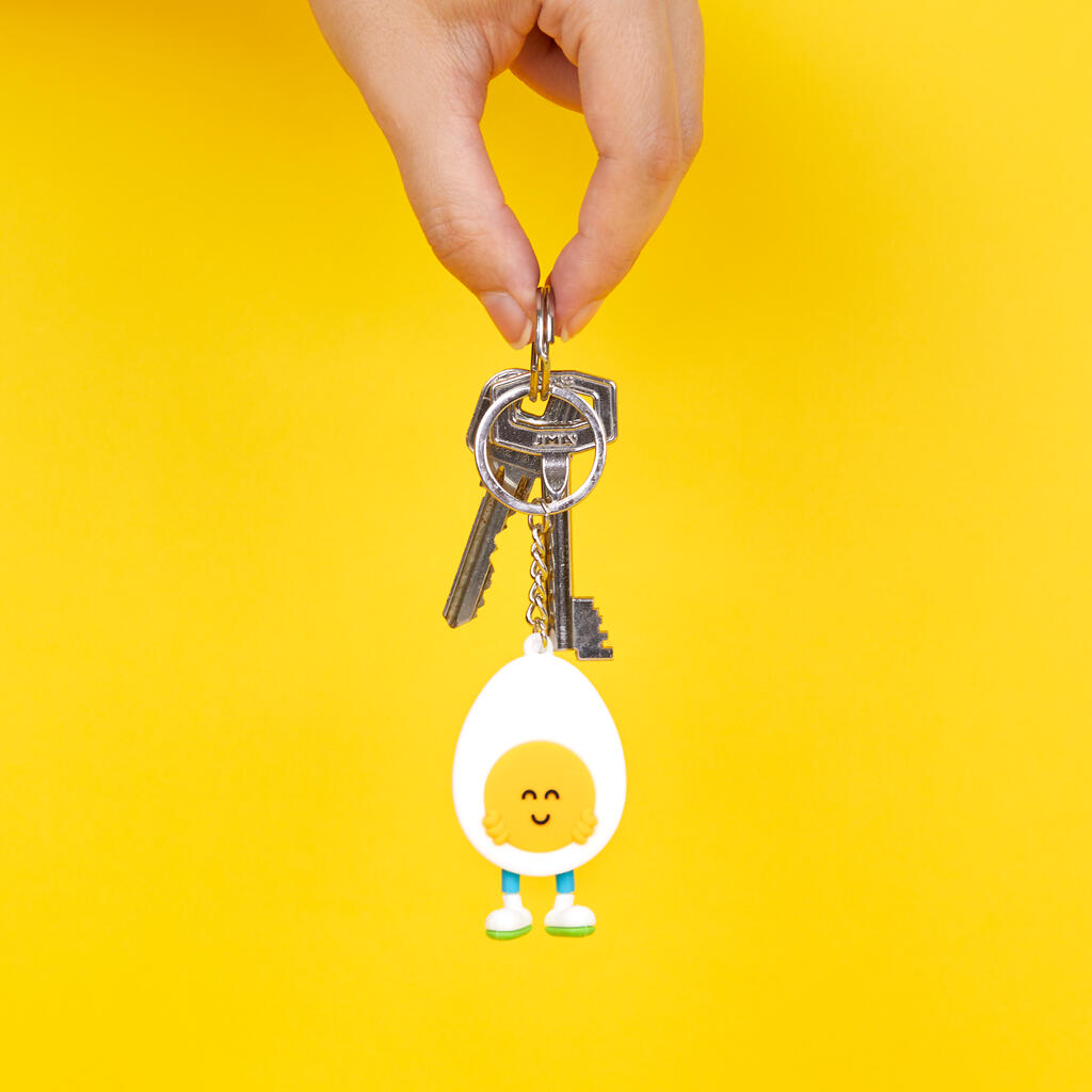 Porte-clés en forme d'œuf souriant sur fond clair