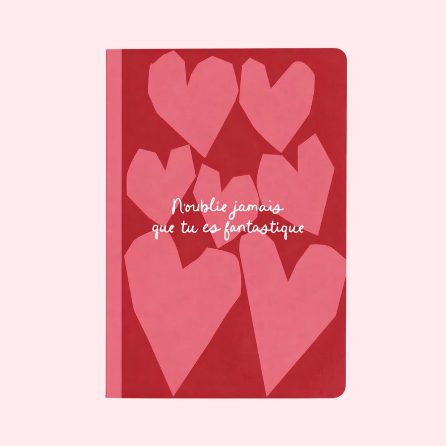 Carnet coloré avec des cœurs, message inspirant en couverture