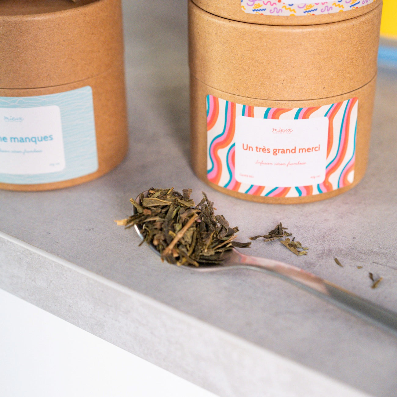 Boîte de thé avec message, vue de face et étiquette colorée.