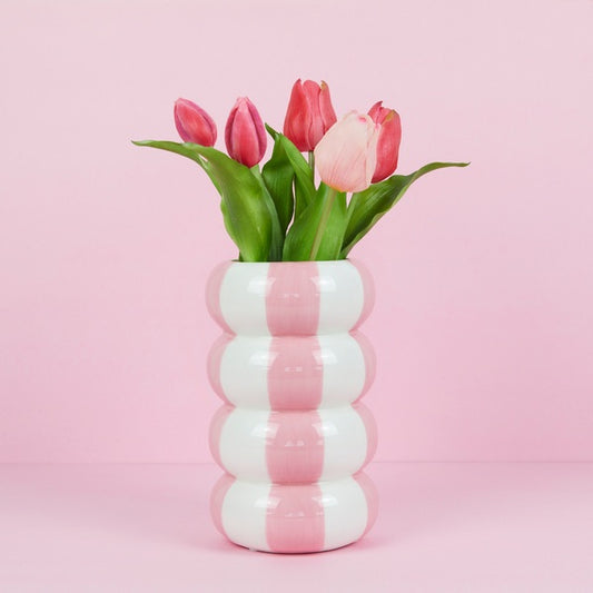 Vase rose en forme de bouées empilées, design original.