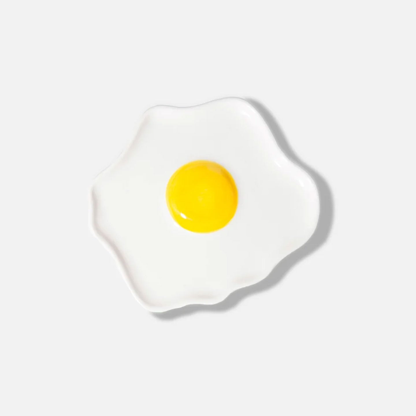 Vide poche en forme d'œuf au plat, vue de dessus.