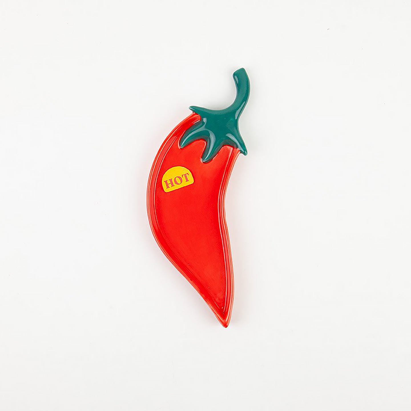 Repose cuillère en forme de piment sur fond blanc