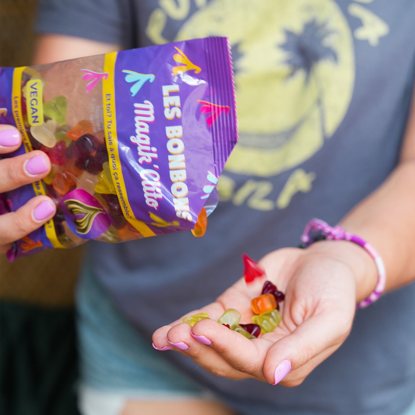Bonbons en forme de clitoris colorés sur fond blanc.