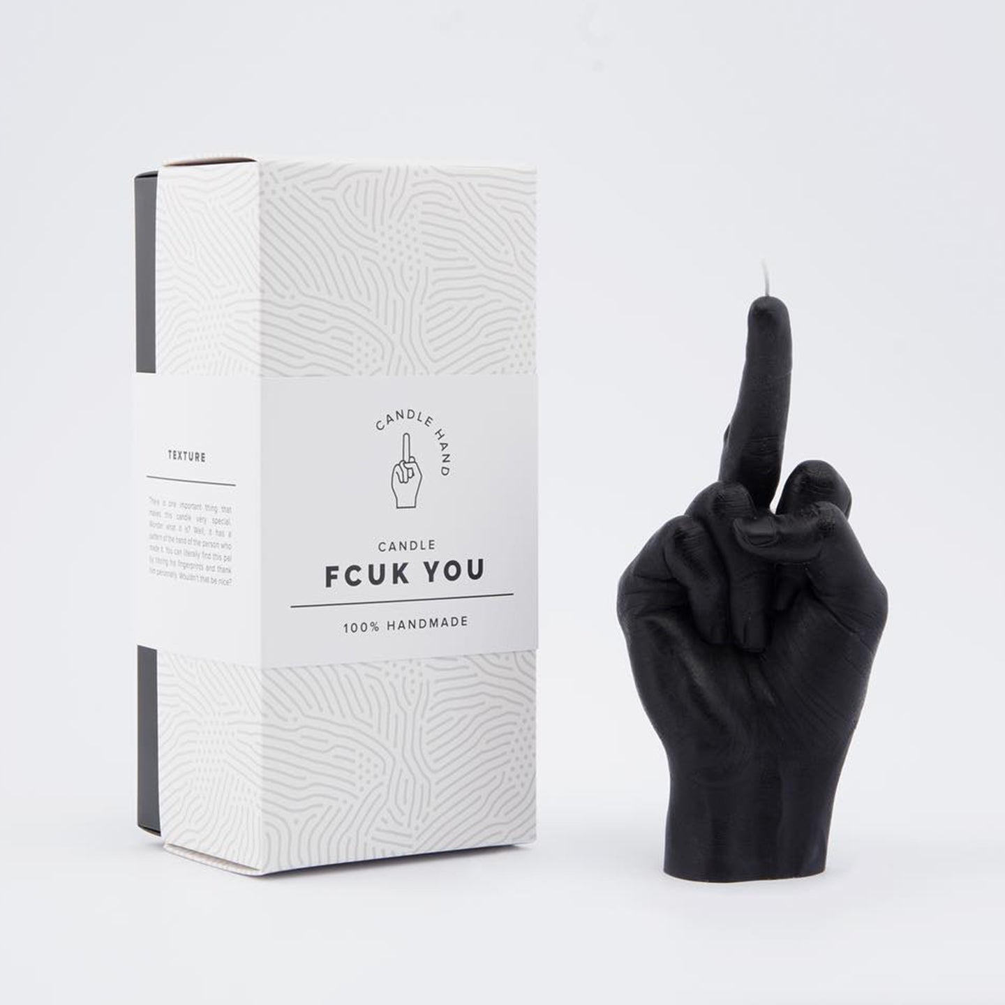 Bougie en forme de doigt d'honneur sur fond neutre