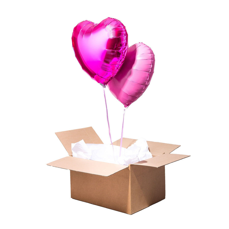 Box 2 Ballons Coeurs avec ballons en forme de coeurs roses dans une boîte cadeau.