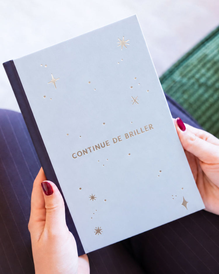 Carnet ouvert montrant ses 100 pages blanches et le message inspirant