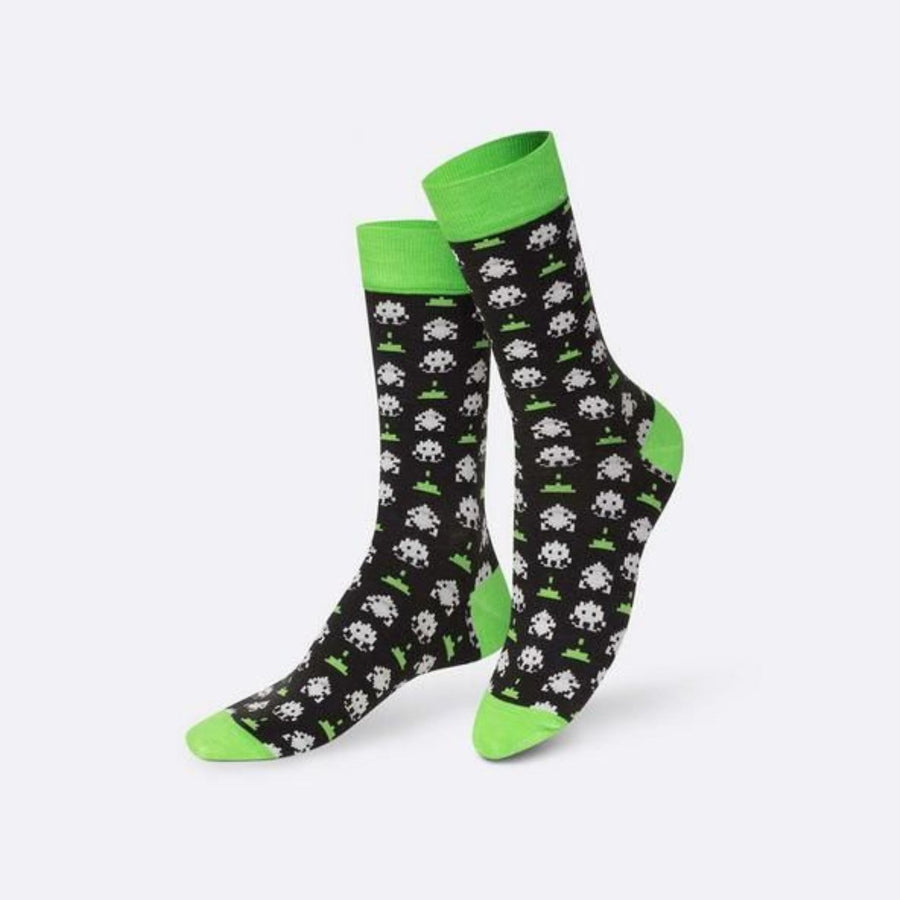 Chaussettes avec motifs de jeux vidéo vintage et aliens pixelisés.