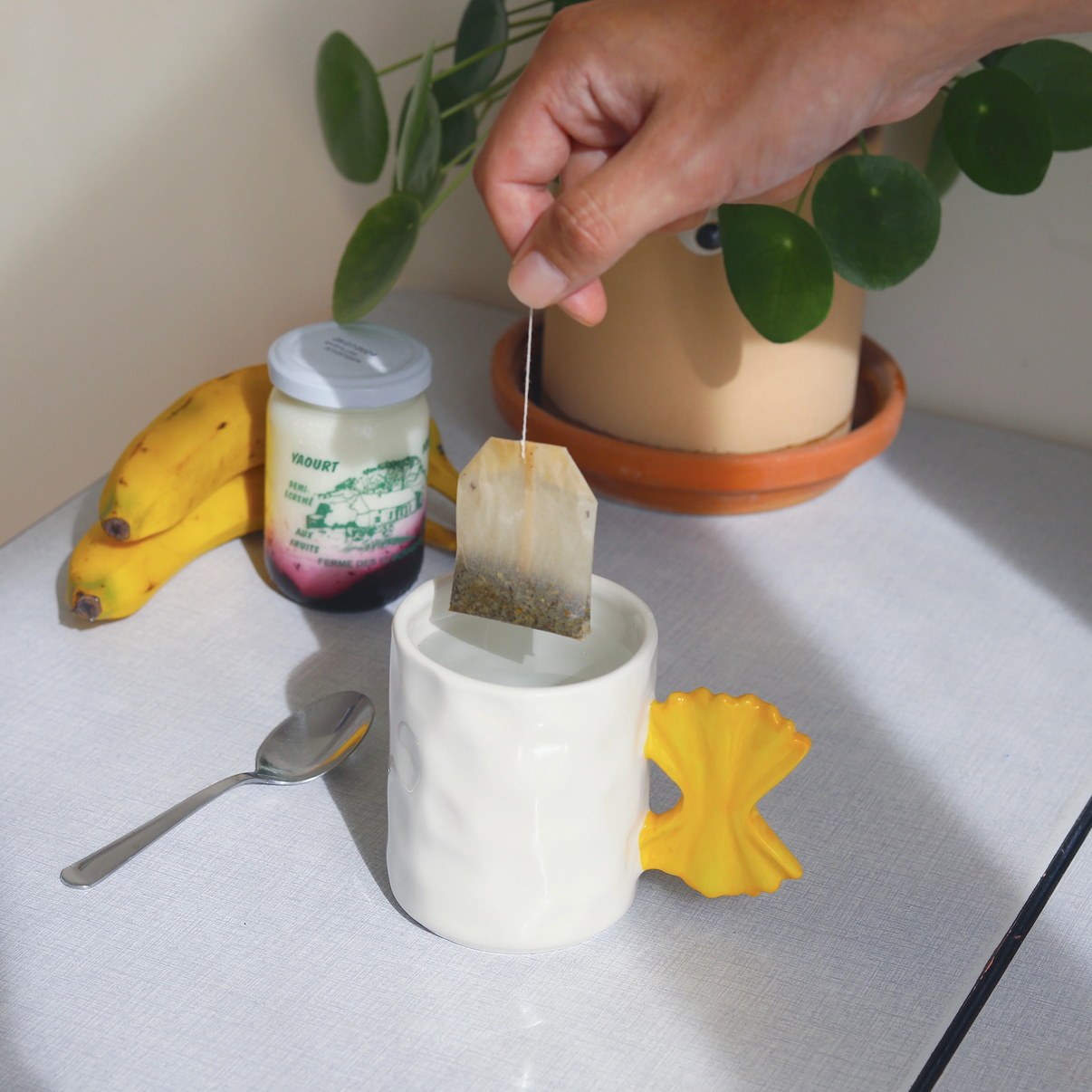Mug avec poignée en forme de pâte farfalle, design unique.