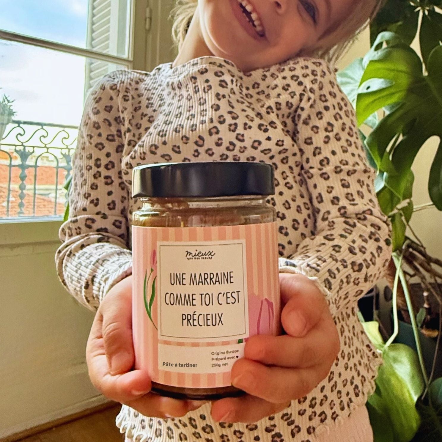 Pot de pâte à tartiner avec étiquette colorée et design joyeux.