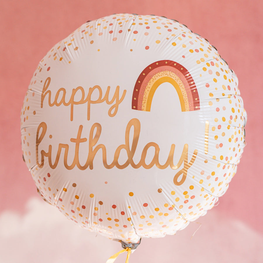 Ballon arc-en-ciel 'Happy Birthday' avec confettis colorés.