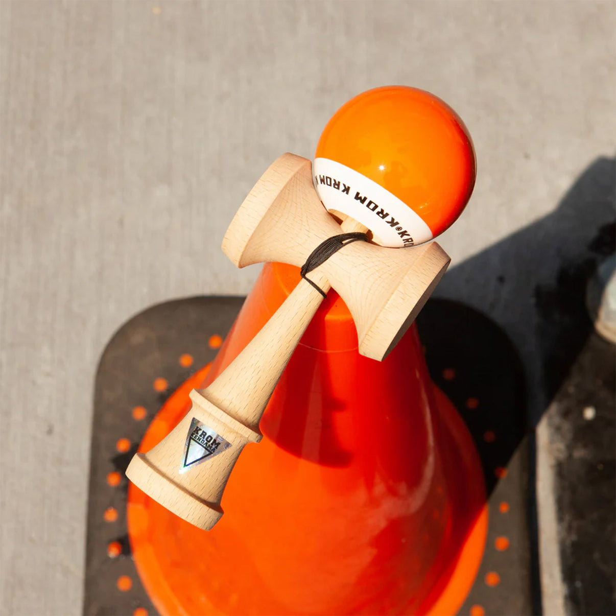Kendama en bois avec boule en équilibre sur le pic central.
