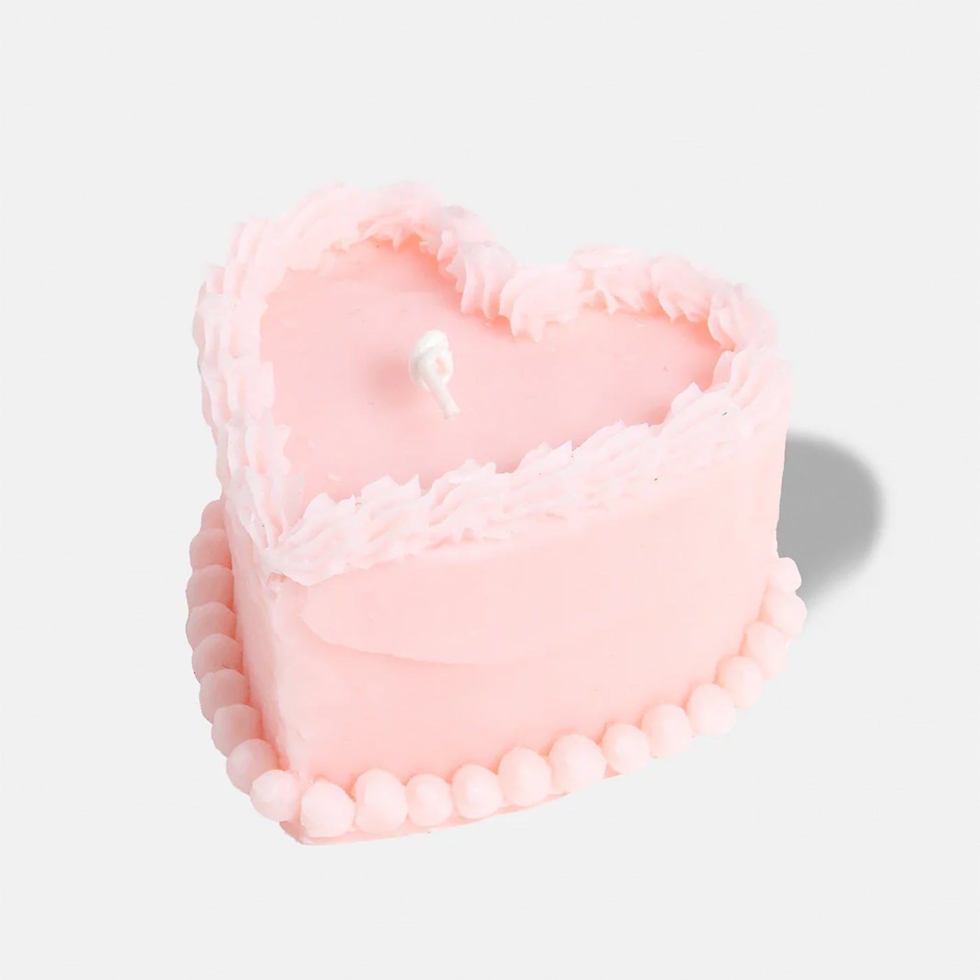 Bougie rose en forme de gâteau avec détails réalistes