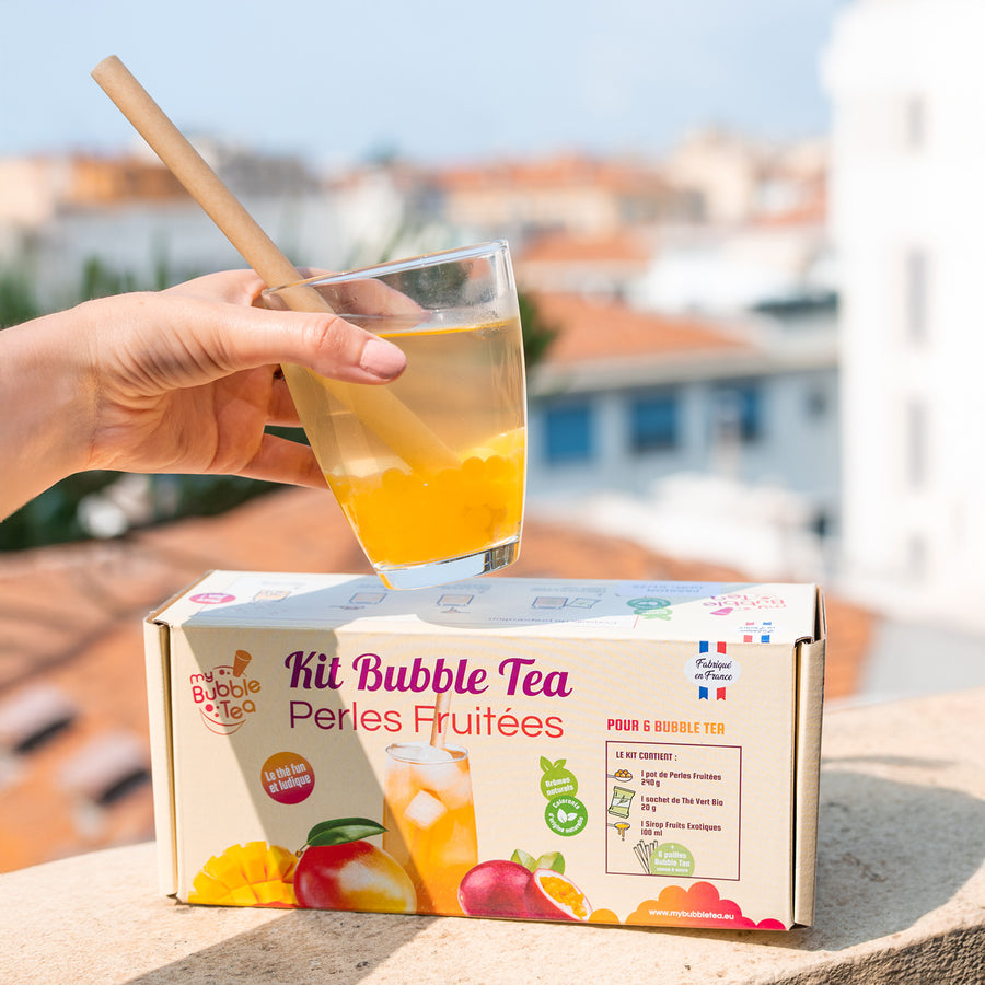 Kit de bubble tea avec perles et accessoires sur fond clair.