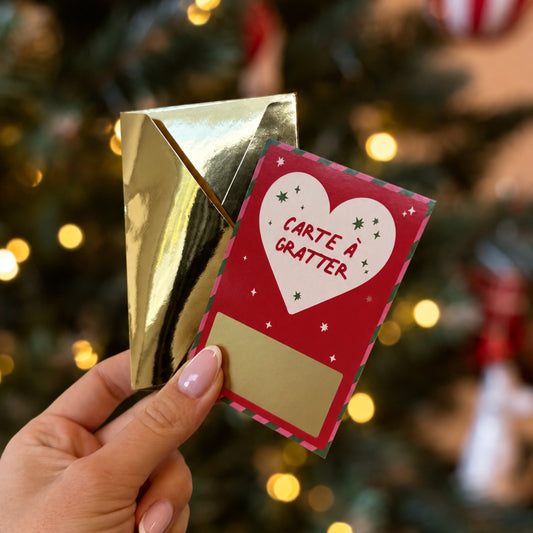 Carte à gratter de Noël rouge, cœur blanc étoilé et zone dorée à révéler