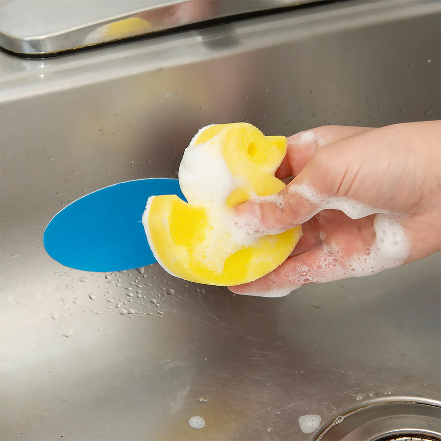 Éponge en forme de canard avec support, vue de face.