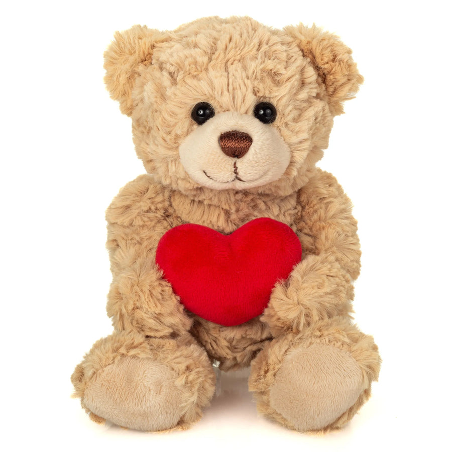 Ourson en peluche tenant un cœur rouge entre ses pattes