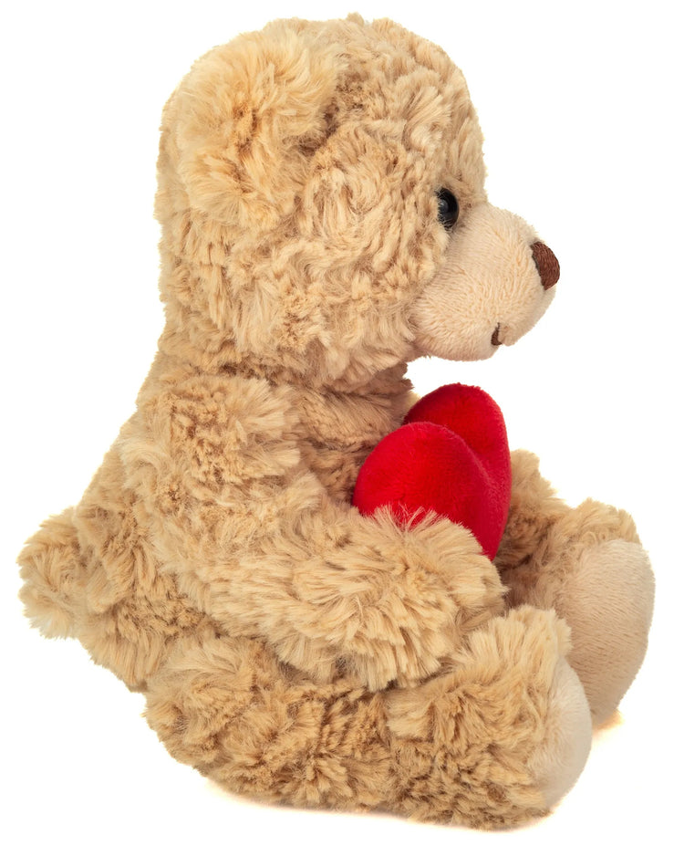 Ourson en peluche tenant un cœur rouge entre ses pattes
