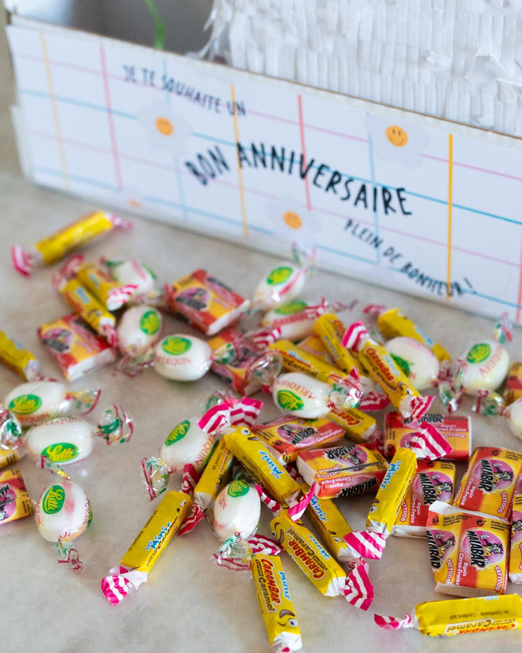 Piñata licorne colorée avec bonbons, vue de côté.