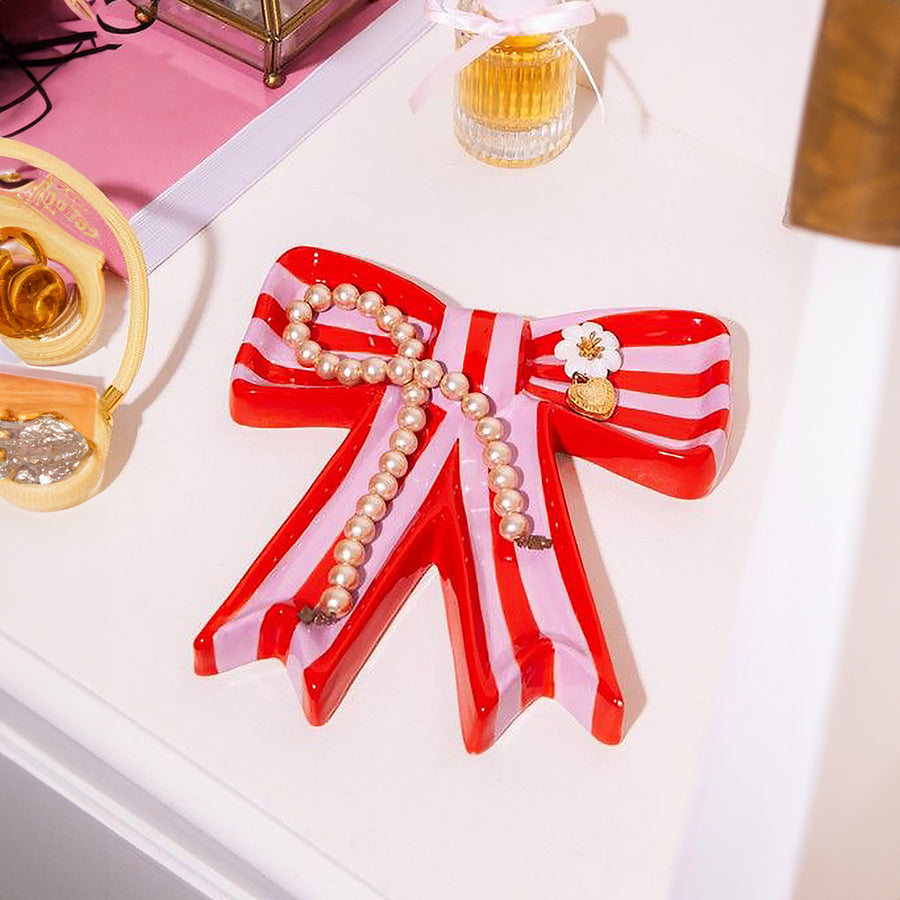 Vide poche en céramique rose avec motif nœud élégant