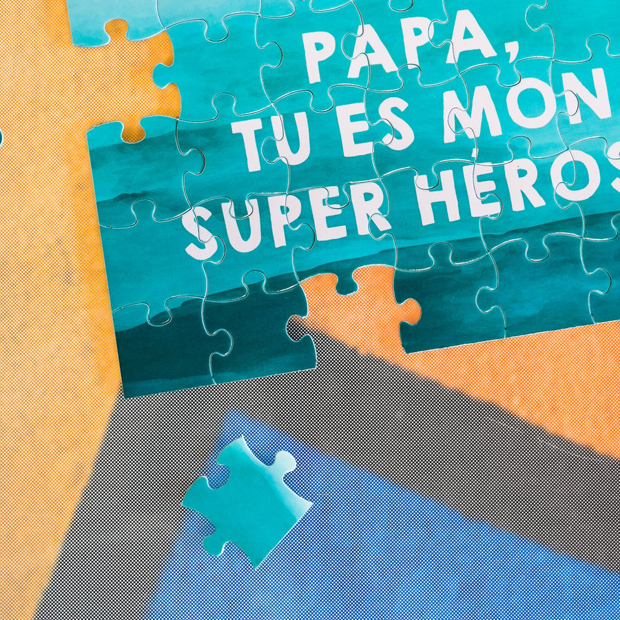 Puzzle avec message 'Papa, tu es mon super héros' en gros plan.