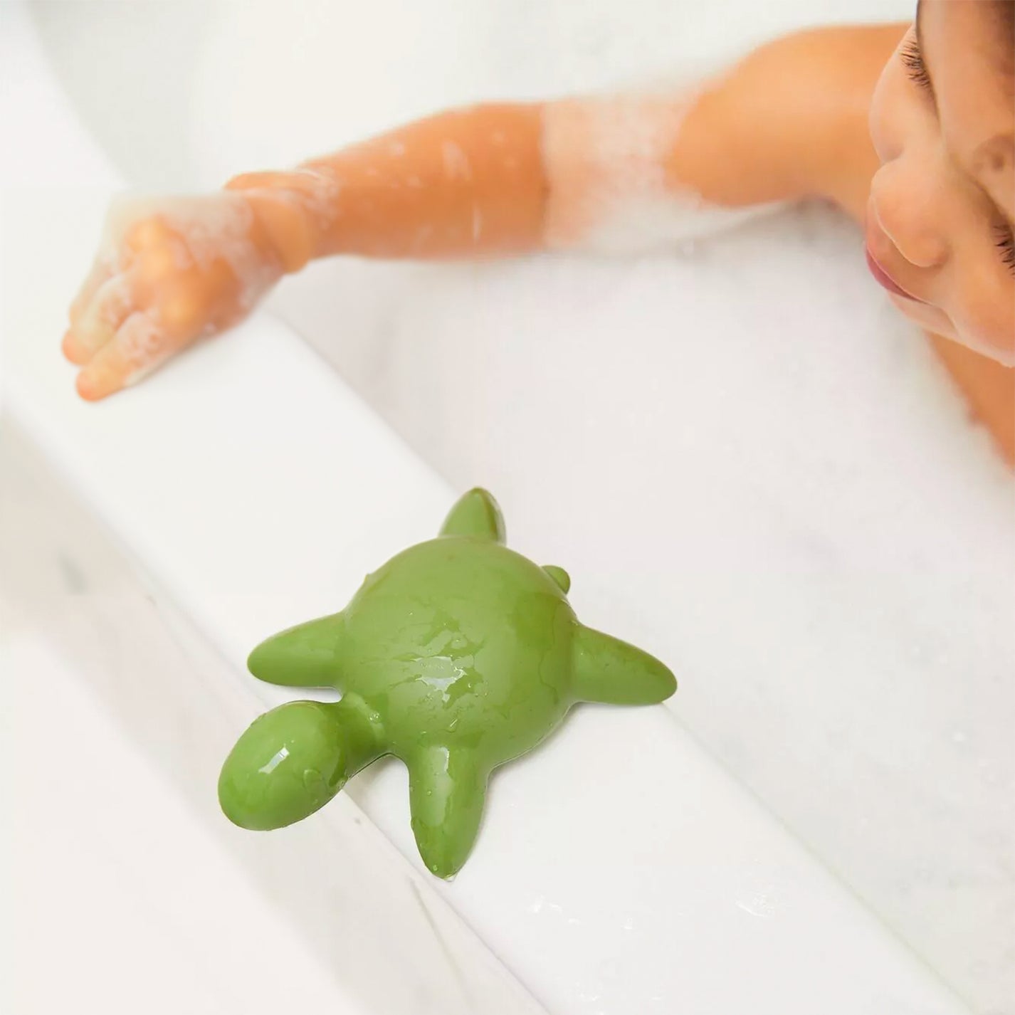 Tortue de bain en filets recyclés, vue de côté avec texture détaillée.
