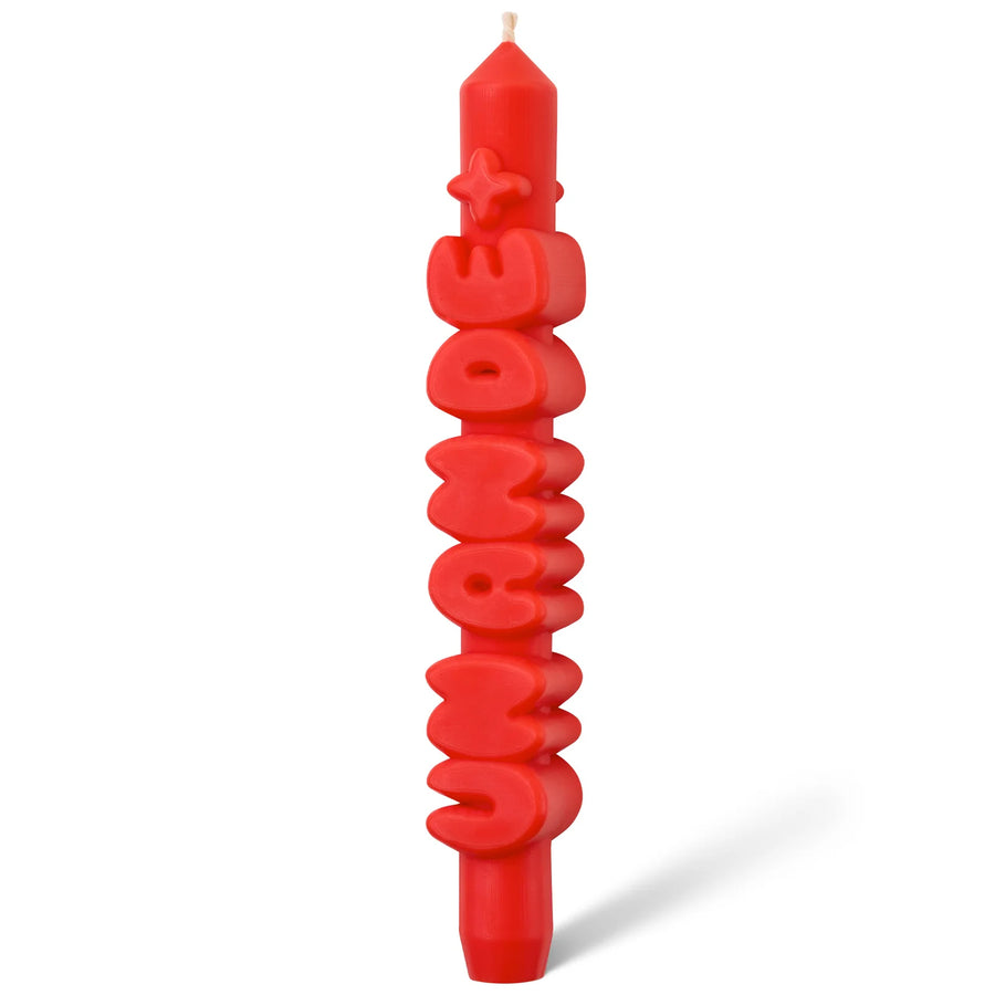 Bougie 'Un an de +' avec motif orange sur fond blanc