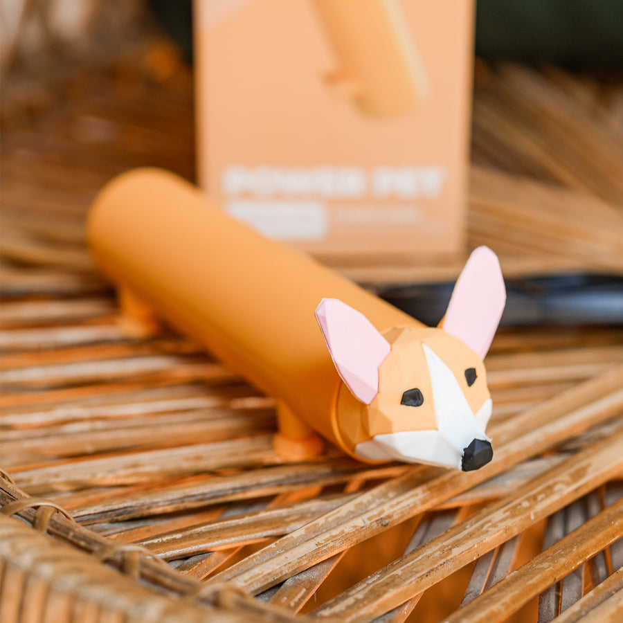 Batterie externe en forme de Corgi avec pattes ventouses.