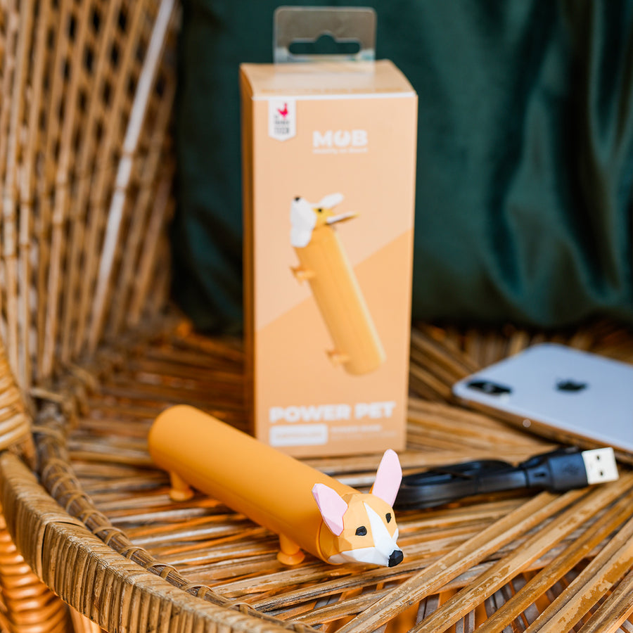 Batterie externe en forme de Corgi avec pattes ventouses.