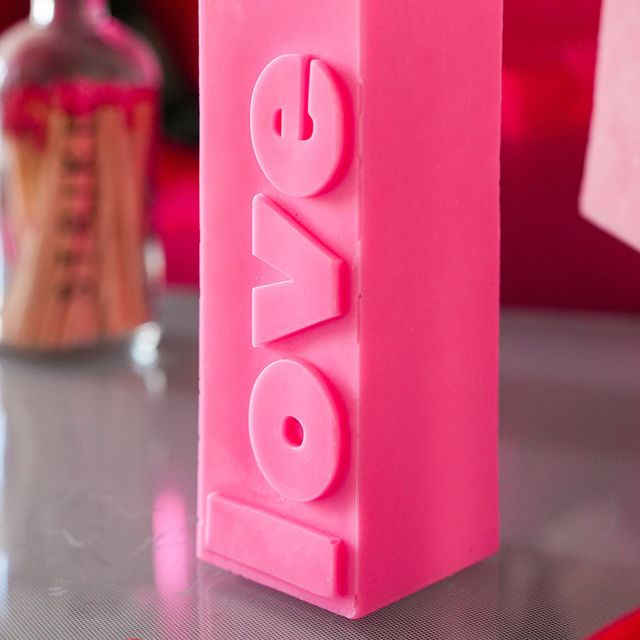 Bougie rose fluo avec message d'amour en relief
