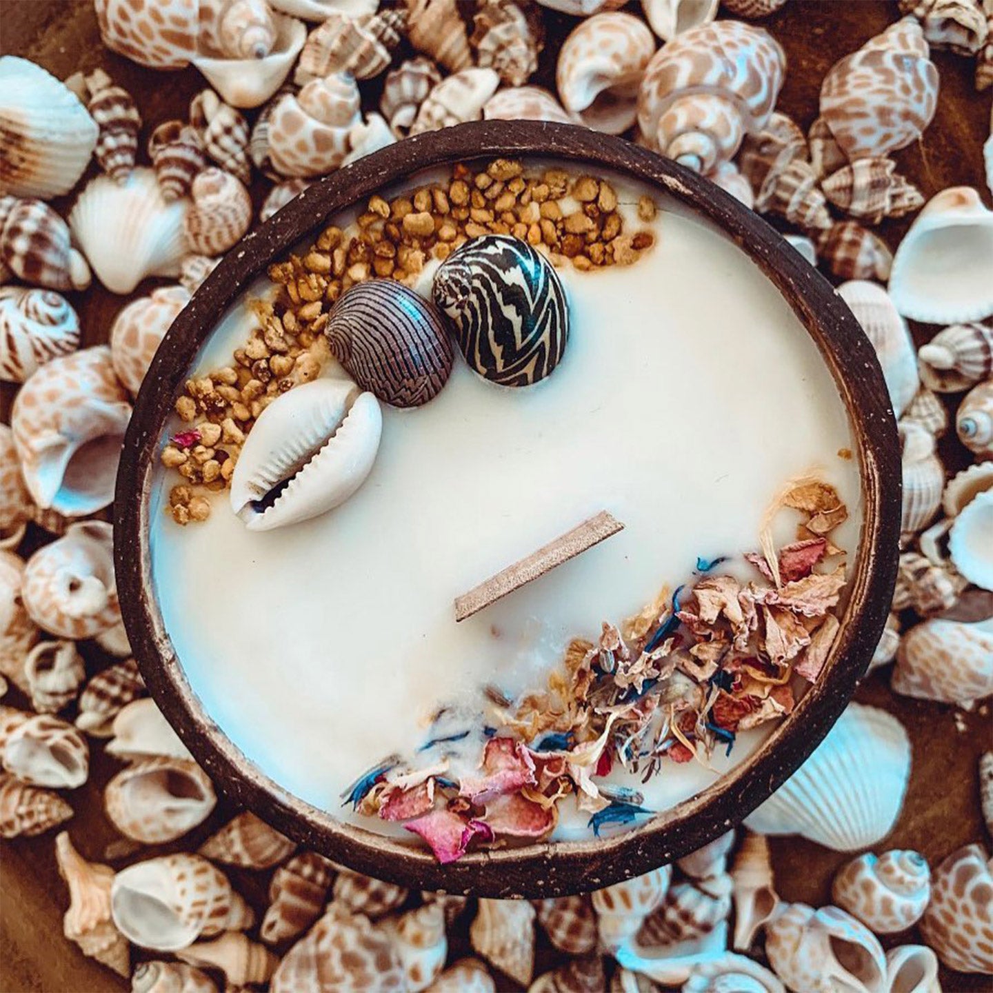 Bougie monoï dans une noix de coco