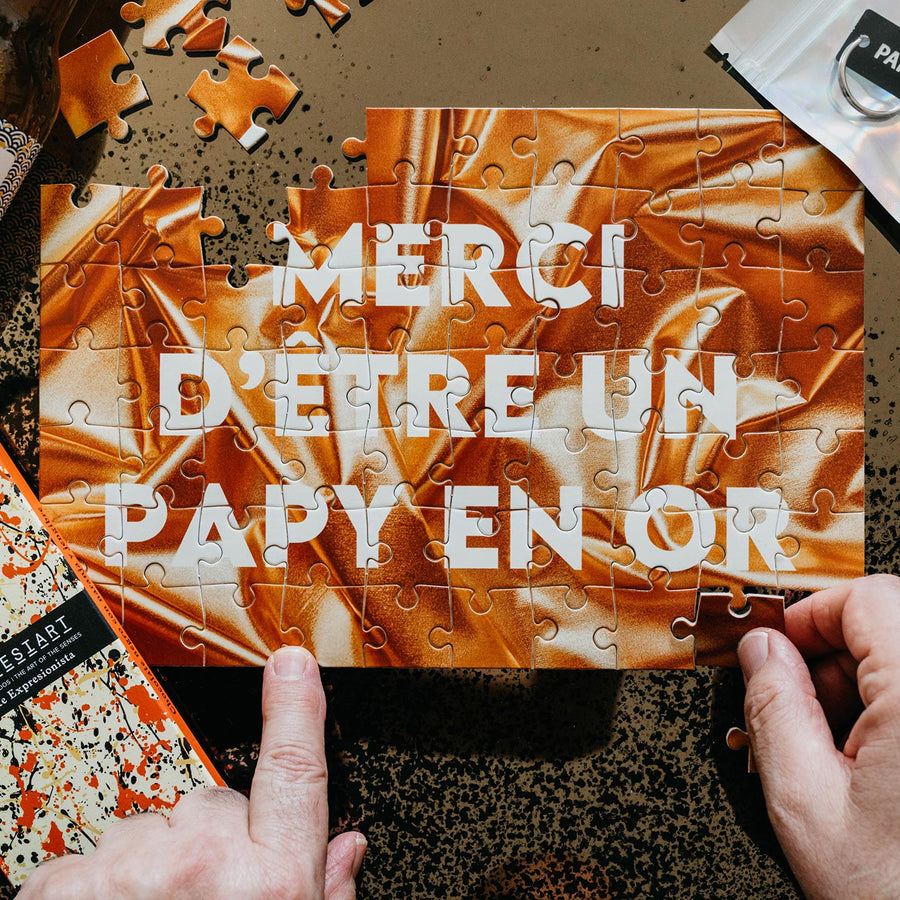 Puzzle de 35 pièces avec message 'papy en or' en gros plan.